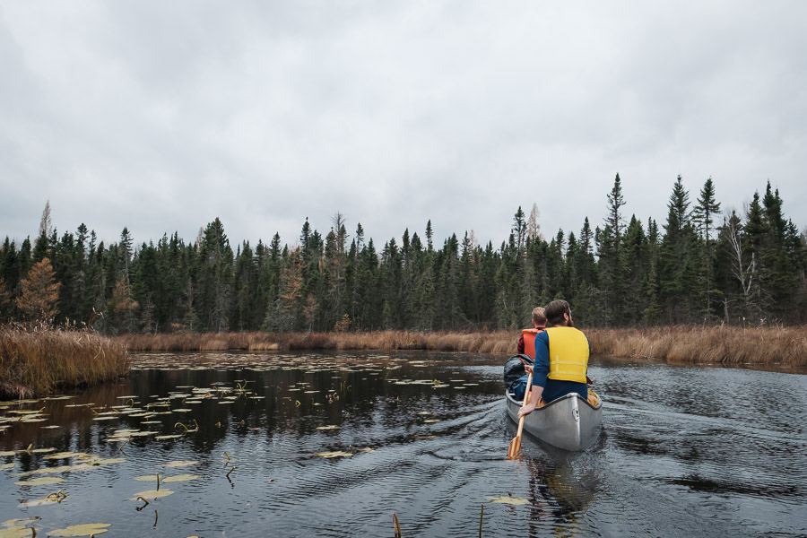In the water, the nearest road quickly falls away into the distance behind. This narrow river near the beginning of our paddle acts as a barrier that keeps motorboats from passing, and beyond it, we enter wilderness.