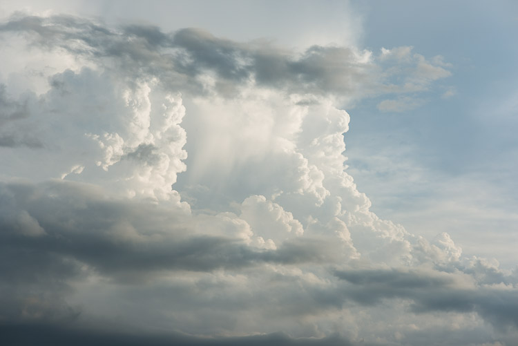 As Wilco steps into the spotlight for the final evening of performances, the crowd watches impending storm clouds rise high above the stage.