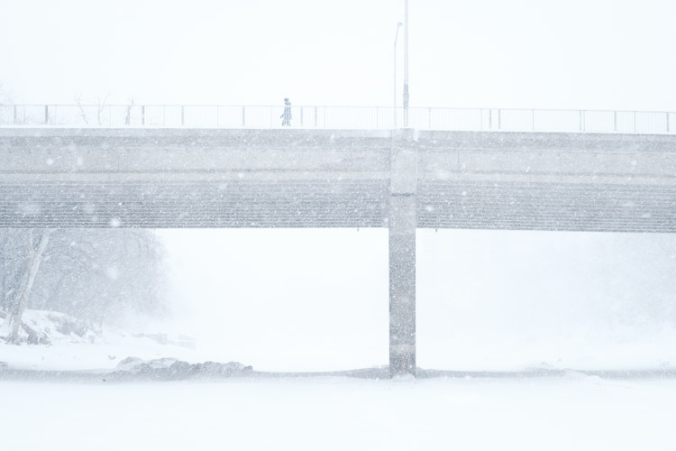 A snowy silhouette crosses the bridge.