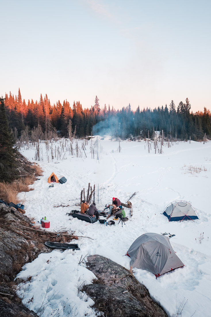 As the sun sets and the temperature drops, the fire becomes a beckoning hub when winter camping.Context: A moment from one of many close-to-home adventures in Manitoba. –link forthcoming–